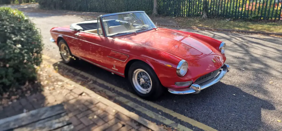 Side shot of classic bright red Ferrari